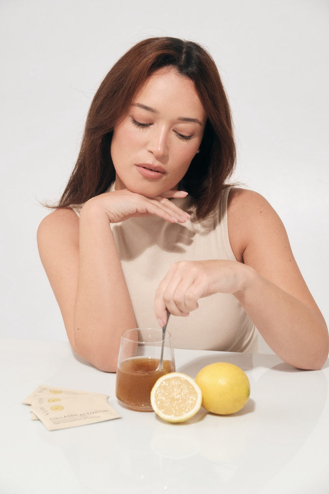 Woman preparing a lemon collagen drink